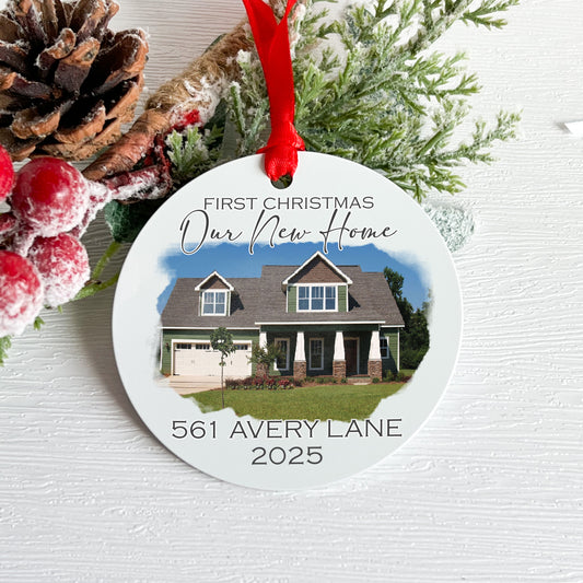 Christmas ornament with house photo and text 'First Christmas Our New Home' on a white background.